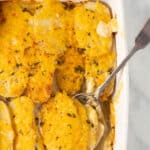 vegan dauphinoise potatoes in baking dish with spoon