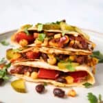 filled black bean quesadillas on a white plate.