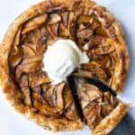 Puff Pastry Apple Tart on a white marble background with a scoop of ice cream in the centre