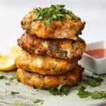 Sweet Chilli Salmon Fishcakes stacked on top of each other, topped with coriander