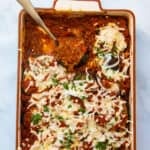 Aubergine bake being served with a silver spoon