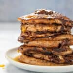 gluten free banana pancakes stacked on a white plate