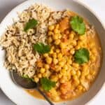 Chickpea curry with rice in a shallow white bowl.