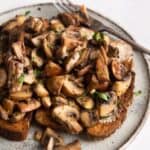 garlic mushrooms on toast with a white plate