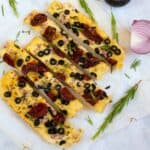 sliced focaccia on white parchment paper