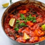 sweet potato and chickpea curry served in a large green pot.