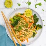 peanut butter noodles with vegetables in a bowl.