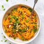 Red Pepper Pasta served in a white bowl with a metal fork