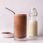 Peanut Butter Milkshake next to milk in a glass bottle.