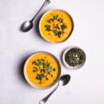 Pumpkin and Butternut Soup served in two white bowls.