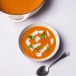 Roasted Tomato Soup with vegan cream and fresh basil on top.