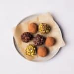 Vegan Chocolate Truffles on a plate with different toppings.