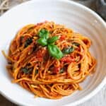 Cherry Tomato Pasta with fresh basil leaves on top.