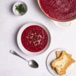 beetroot soup served with toast and fresh dill.
