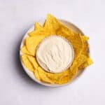 vegan sour cream with chips in a bowl.