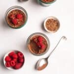 vegan chocolate mousse with raspberries on top.