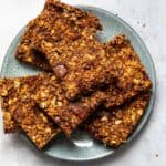 chocolate flapjacks sliced into squares served on a blue plate.
