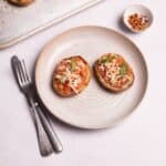 loaded potato skins with fresh basil leaves.