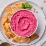 beetroot hummus served with pita chips.