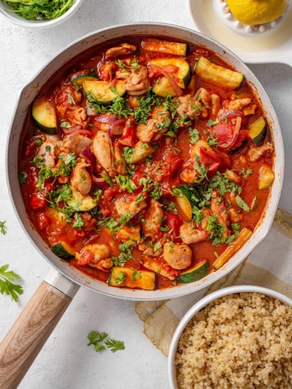 One-Pot Harissa Chicken with Courgette & Tomatoes served in a pan with quinoa