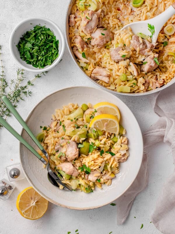 One-Pot Chicken and Leek Orzo served in a bowl with lemon and parsley